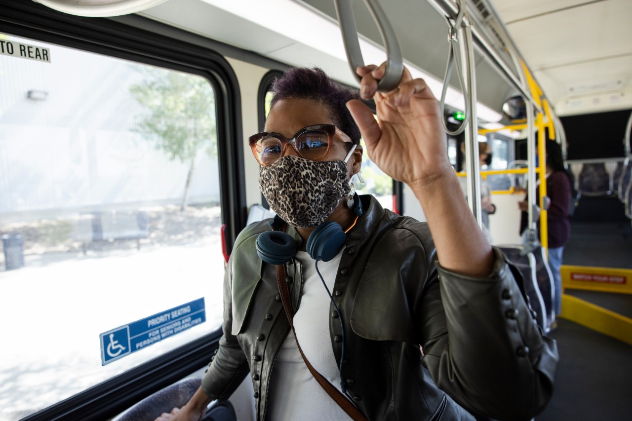 person on a bus wearing a mask